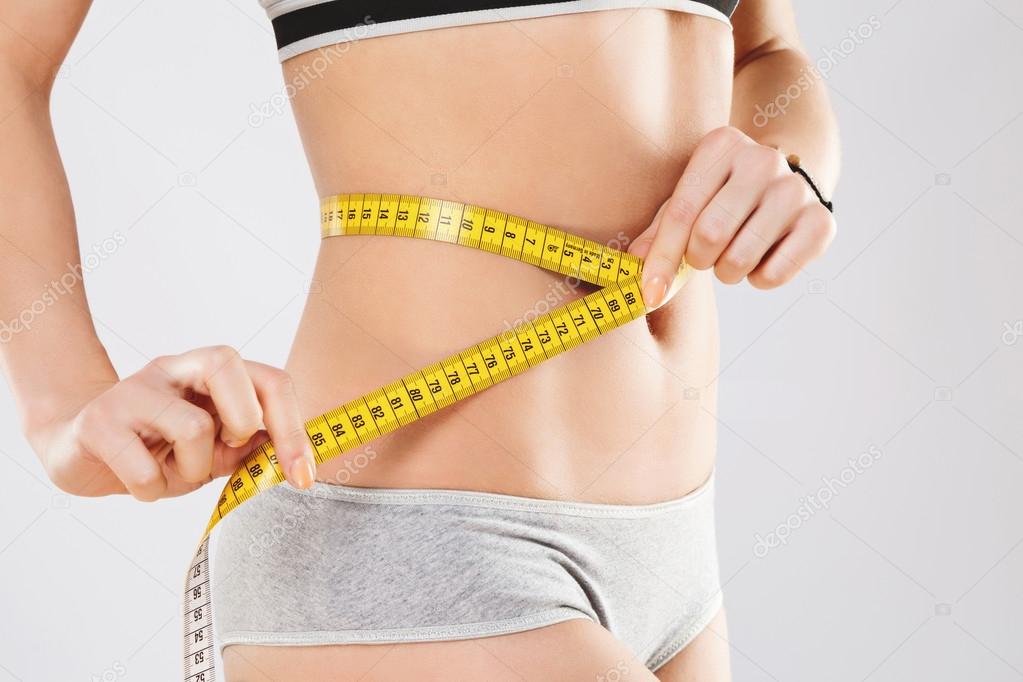 Measuring tape on girl's body Stock Photo by ©VelesStudio 117384564